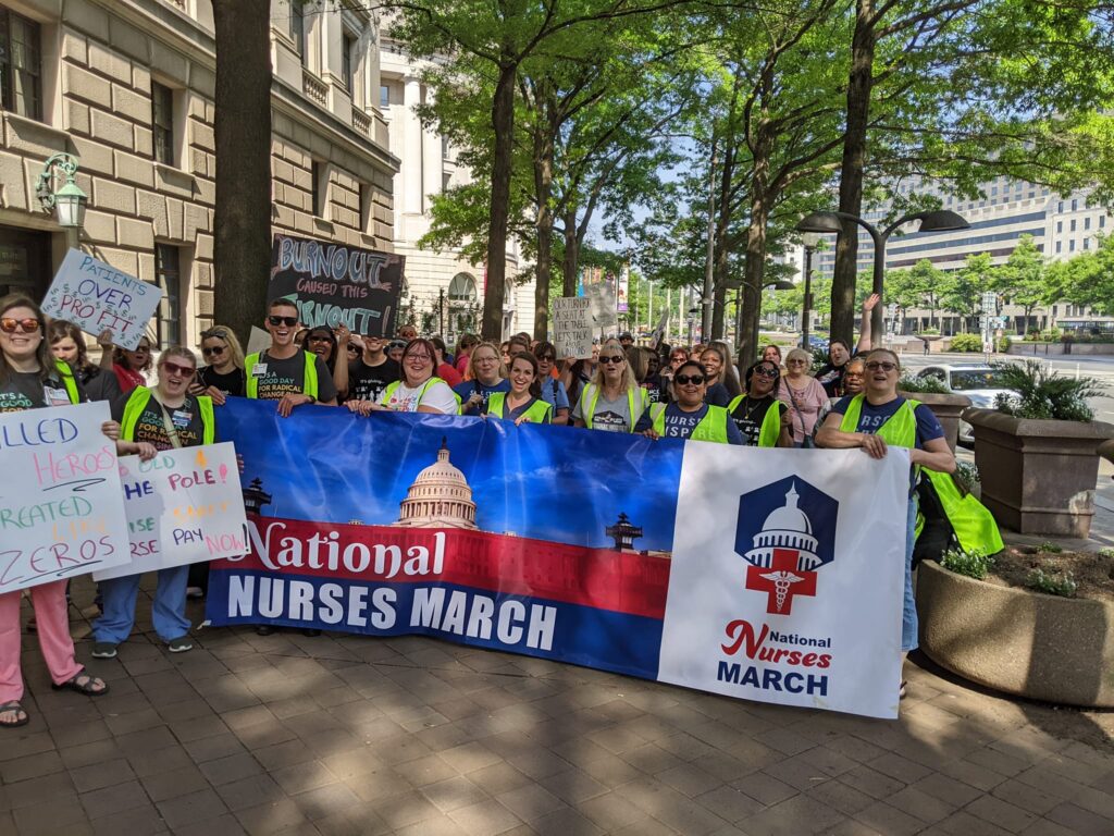 National Nurses March banner surrounded by marching nurses